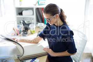 Female executive looking at sample book