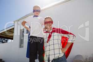 Mother and son pretending to be superhero in the backyard