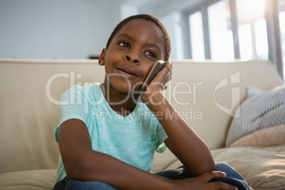Boy talking on mobile phone in the living room