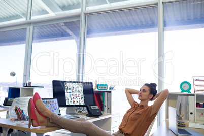 Female executive relaxing at her desk