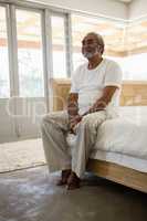 Senior man relaxing on bed at home