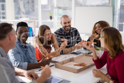 Group of executives interacting while having pizza