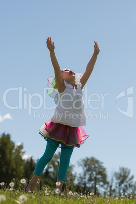 Excited girl playing in park