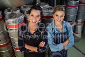 Portrait of smiling female coworkers with arms crossed