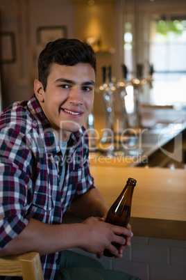 Portrait of man holding beer bottle