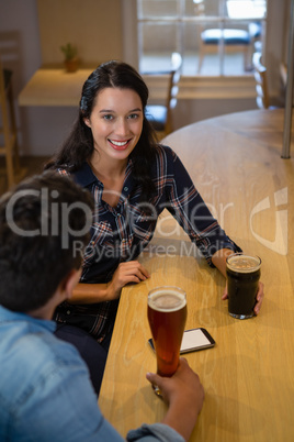 Portrait of beautiful woman with friend at bar