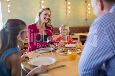 Happy family talking in restaurant