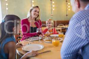 Happy family talking in restaurant