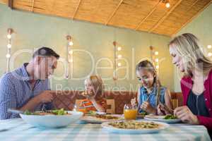 Family having food at restaurant