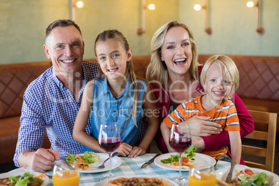 Portrait of cheerful family at restaurant