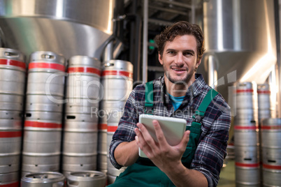 Portrait of worker using tablet computer in warehouse