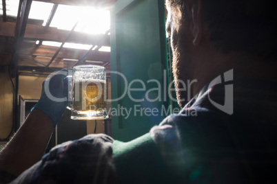 Worker holding beer glass