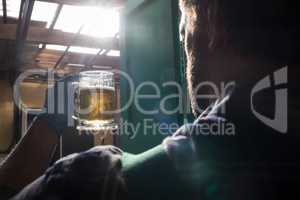 Worker holding beer glass