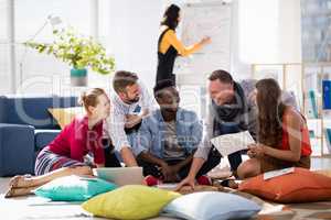 Business colleagues having pizza together while working in office