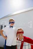 Mother and son pretending to be superhero in the backyard