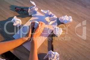 Woman with crumpled paper on her desk