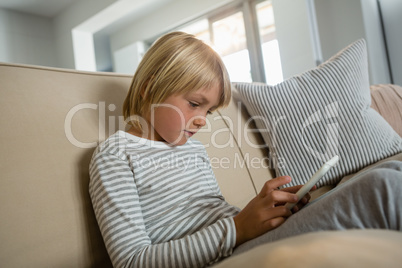 Boy using digital tablet in the living room