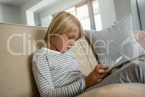 Boy using digital tablet in the living room