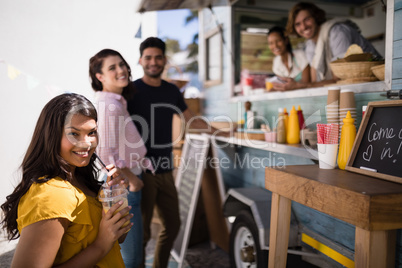 Portrait of friends smiling at counter