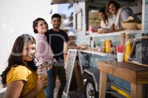 Portrait of friends smiling at counter