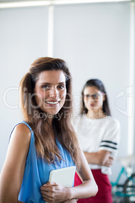 Female executive holding digital tablet in office