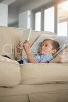 Boy using digital tablet in the living room