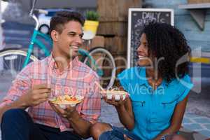 Happy couple looking at each other while having meal