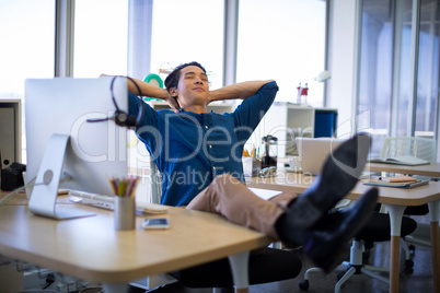 Male executive relaxing at his desk