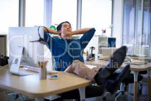 Male executive relaxing at his desk