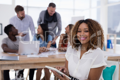 Young female executive using digital tablet in the office