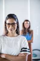 Female executive in spectacle standing in office