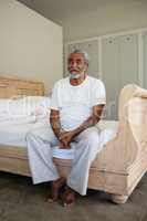 Senior man relaxing on bed at home