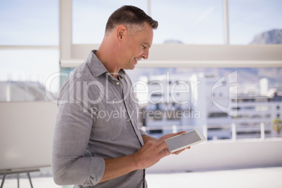 Happy executive using digital tablet