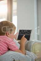 Boy using digital tablet in the living room