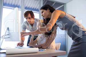 Executives discussing over computer during a meeting