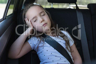 Girl sleeping at back seat of car