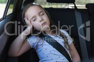 Girl sleeping at back seat of car