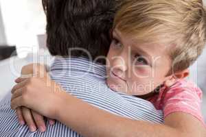 Father and son embracing each other in living room