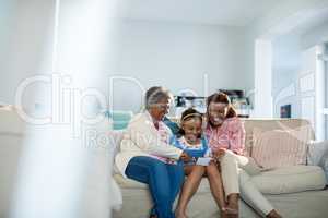 Happy family using mobile phone in living room