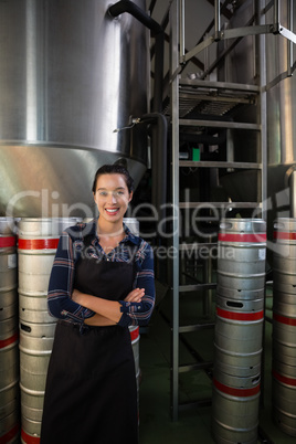 Portrait of confident worker by storage tank