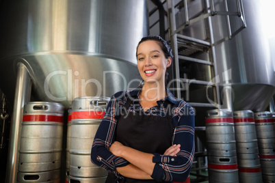 Portrait of young worker standing by storage tank