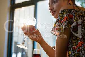 Young woman having red wine