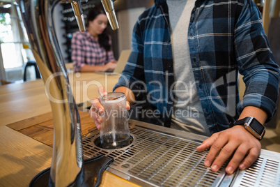 Midsection of bartender preparing drink