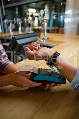 Cropped hand of owner giving bill to customer