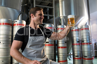 Smiling worker holding beer glass