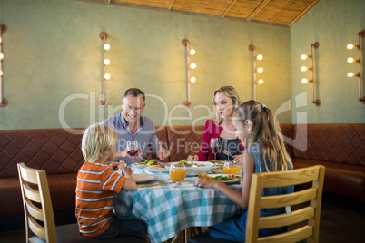 Happy family dining at restauranrt