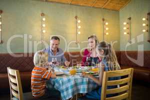 Happy family dining at restauranrt
