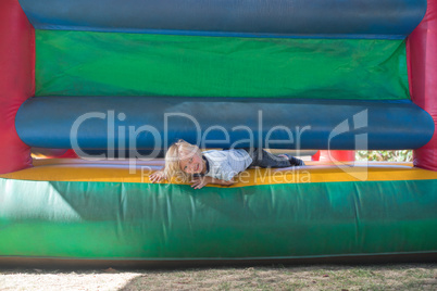 Portrait of happy boy playing on bouncy castle