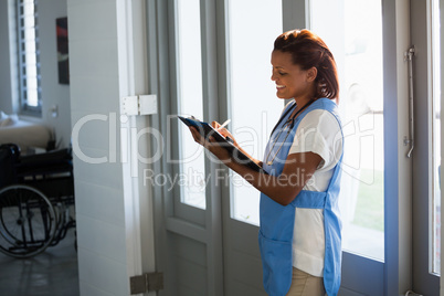 Doctor writing on clipboard in the hospital