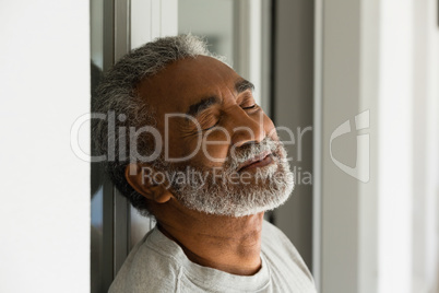 Senior man sleeping at the entrance of house